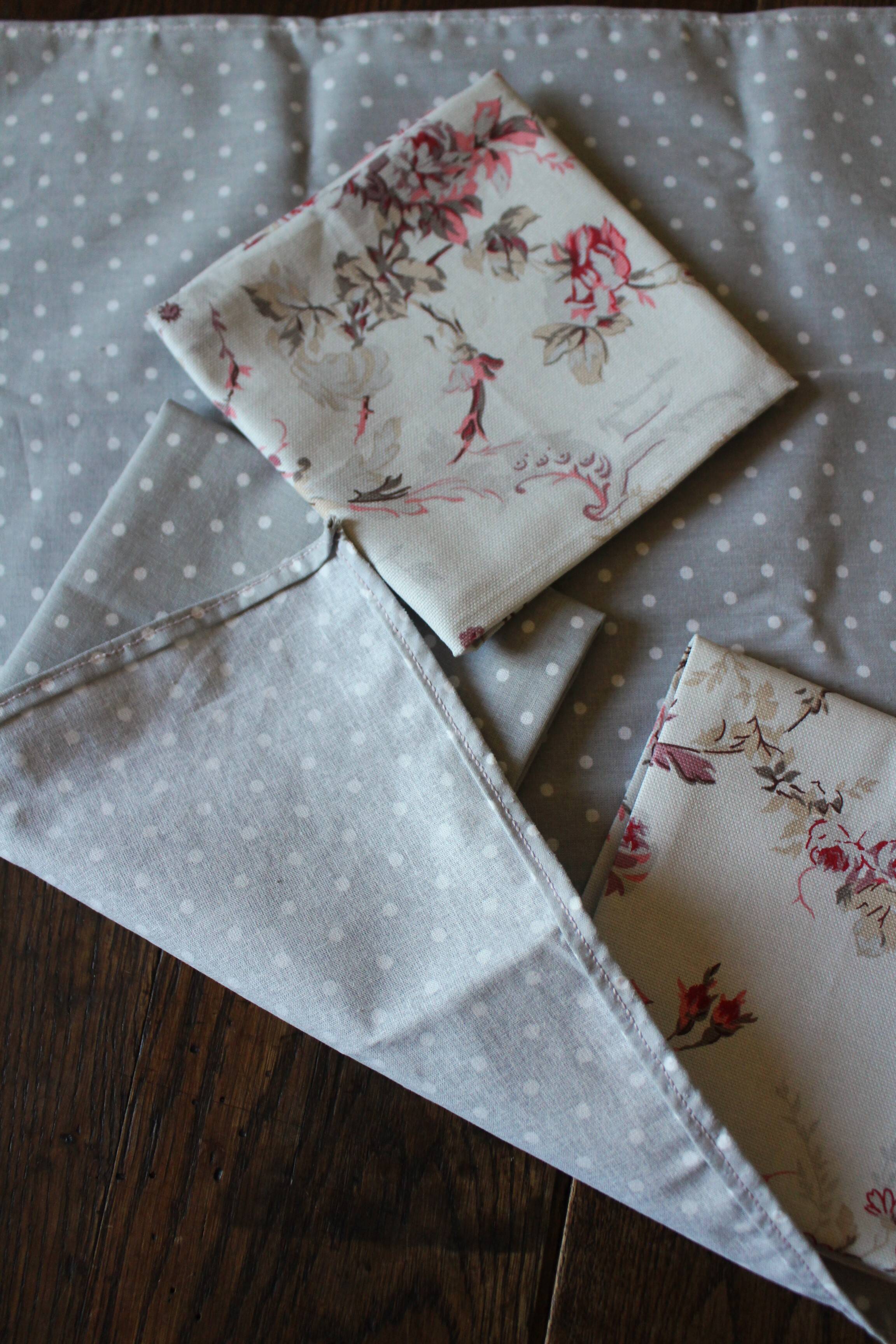 A set of 8 gray blue napkins with pink flowers and polka dots