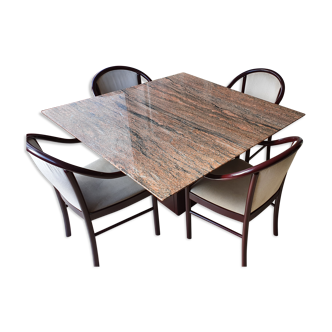 Square table in burgundy marble, its 4 matching chairs in white fabric and its buffet