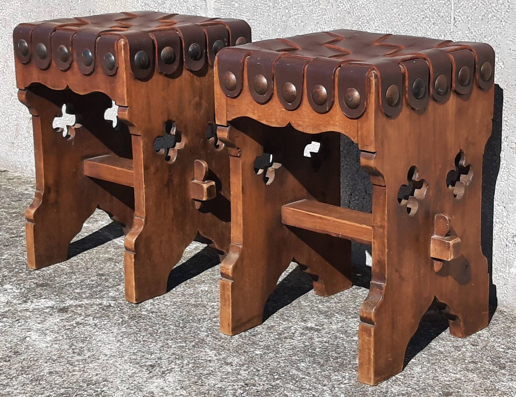 Pair of brutalist stools, leather seat.