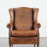 Large sheep leather wingback chair correctly finished with decorative nails