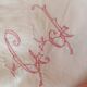 Handmade red lettered pillowcase.
