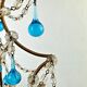 Italian chandelier with blue beads and gilded wood.