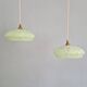 Pair of Art Deco light fixtures in light green speckled glass, 1930s.