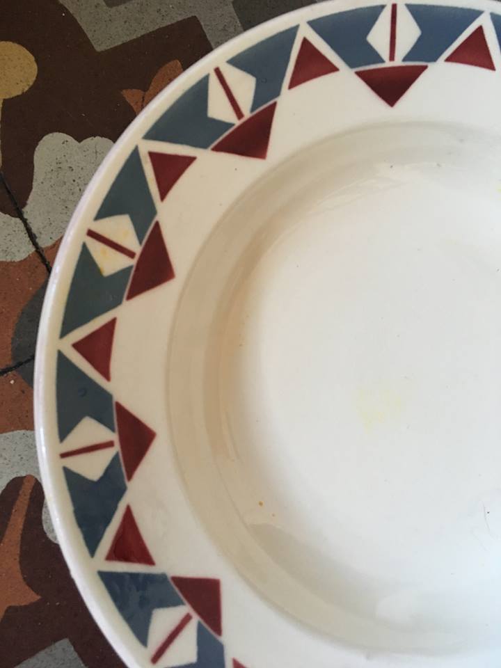 Six soup plates don't match in red and blue.
