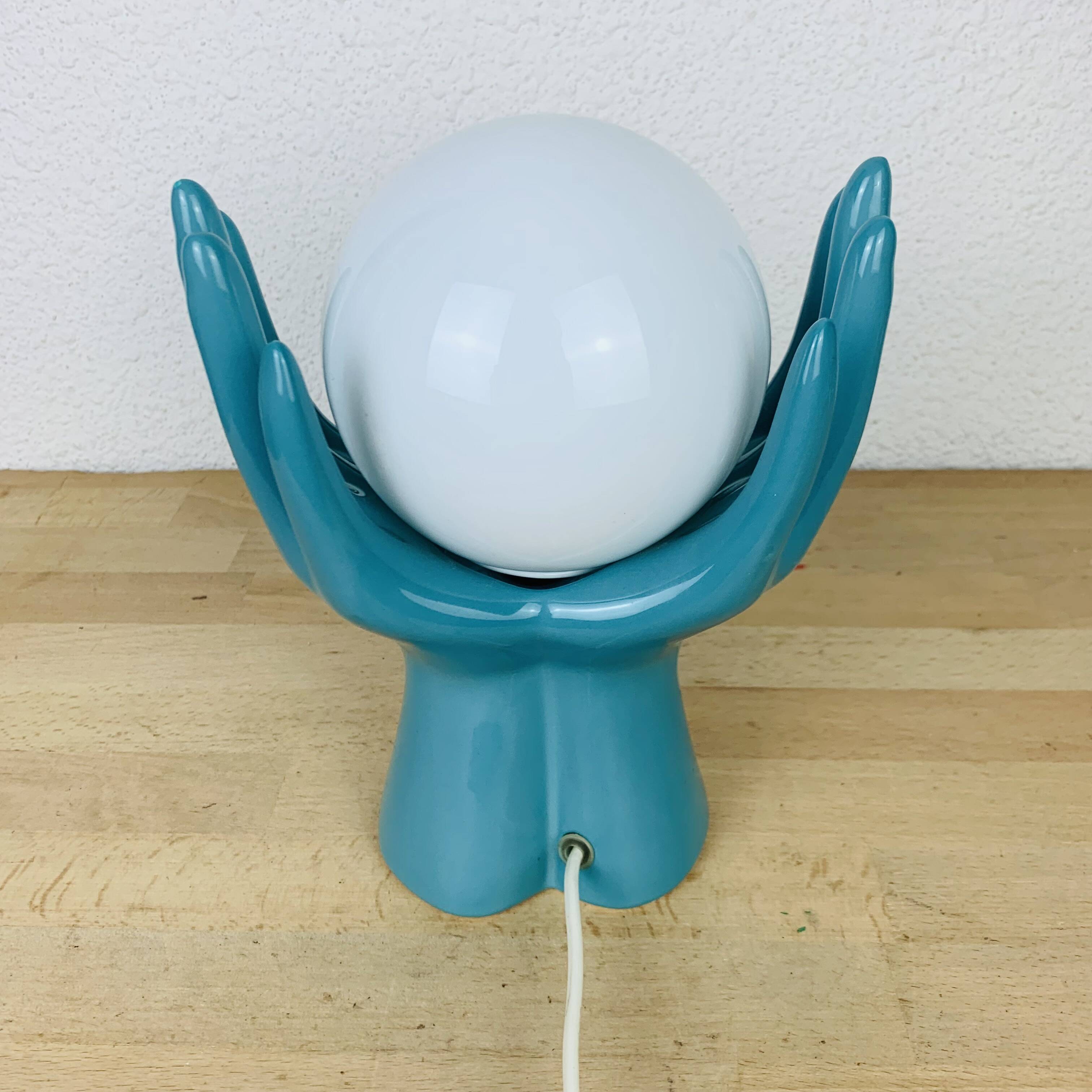 Blue ceramic hands lamp and glass globe