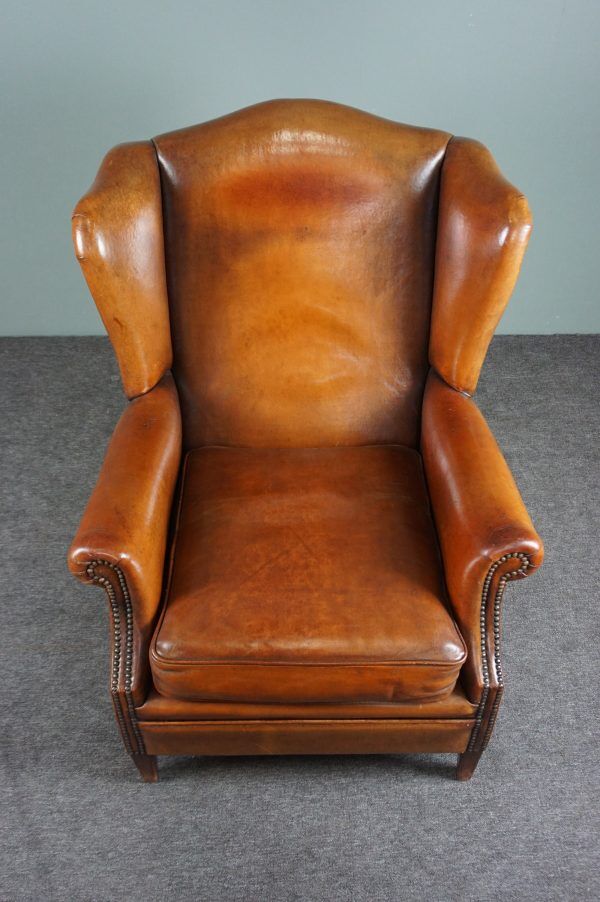 Eared armchair in patinated sheepskin