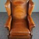Eared armchair in patinated sheepskin