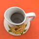 Antique glazed ceramic pitcher with sunflower decoration