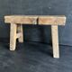 Ancient Chinese farm bench in patinated wood, small rustic stool.