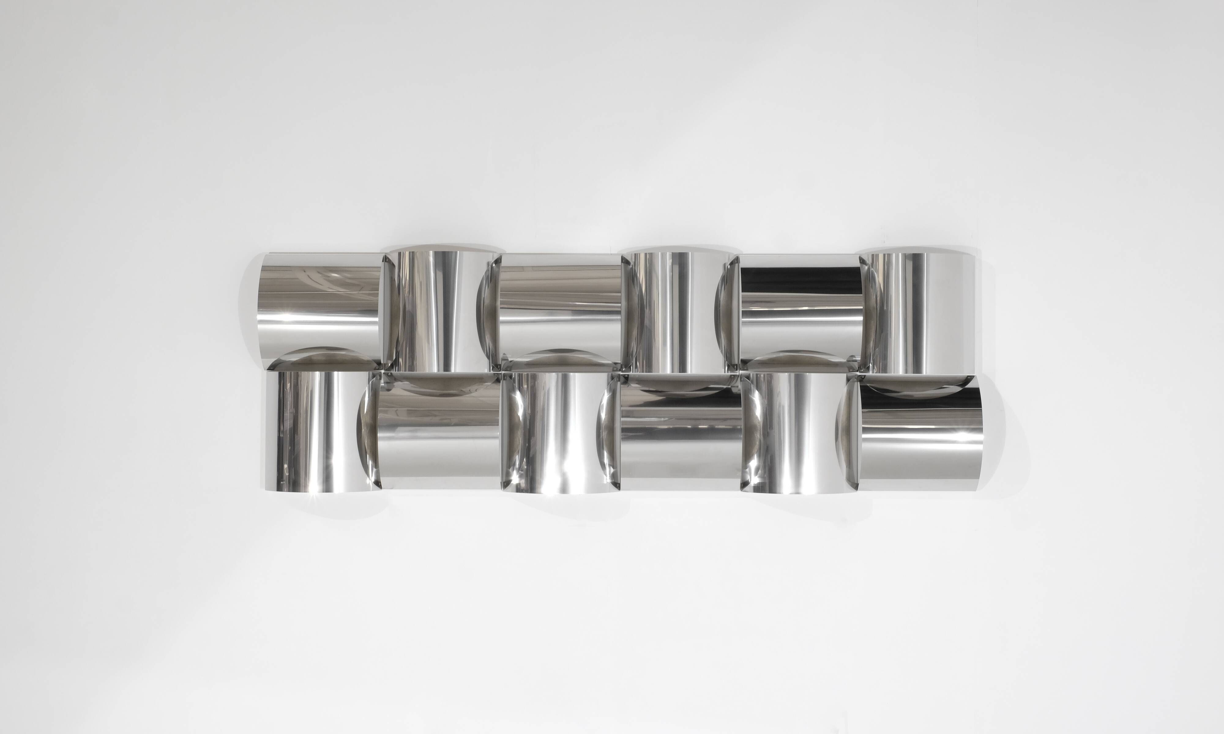 Contemporary wall light in stainless steel and metal.