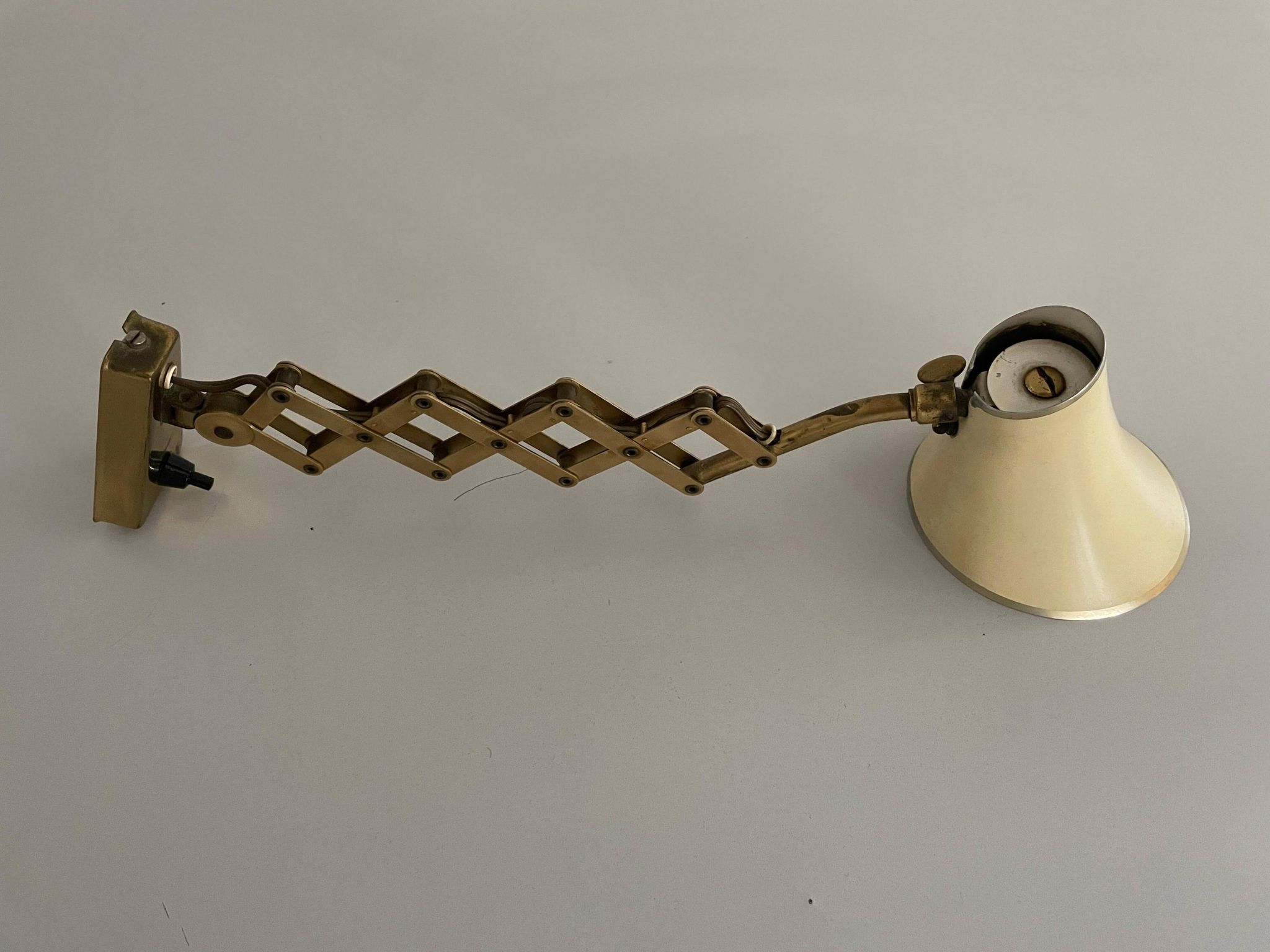 Cream metal and brass wall lamp with scissors design by Karl Lang for SIS Licht, 1950s, Germany.