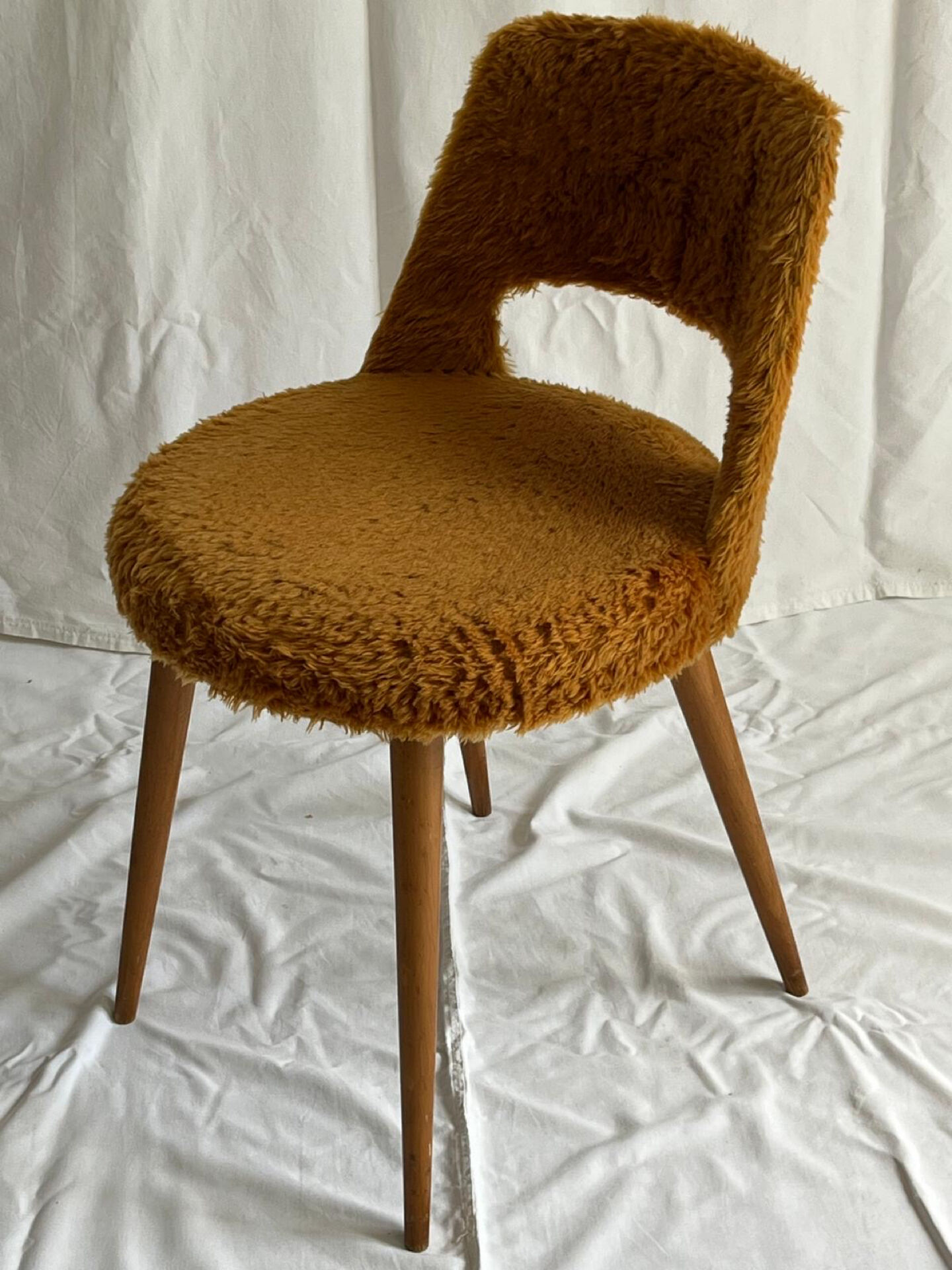 Camel barrel chair with faux fur by Baumann