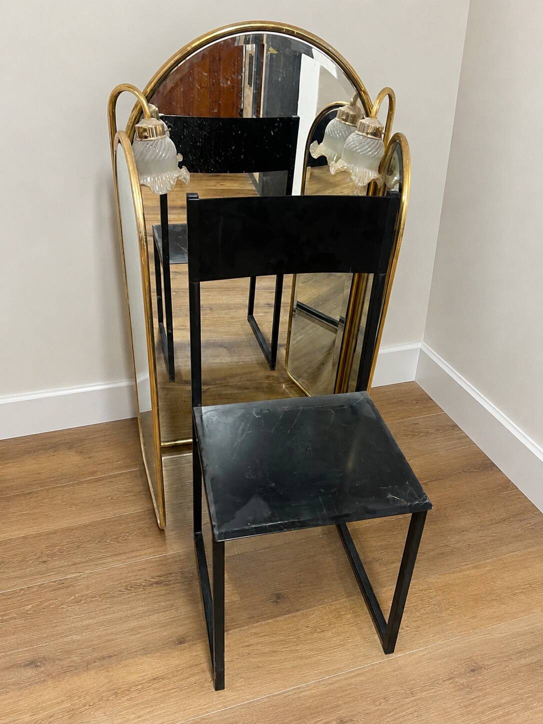 Vintage triptych mirror in brass with wall lights.