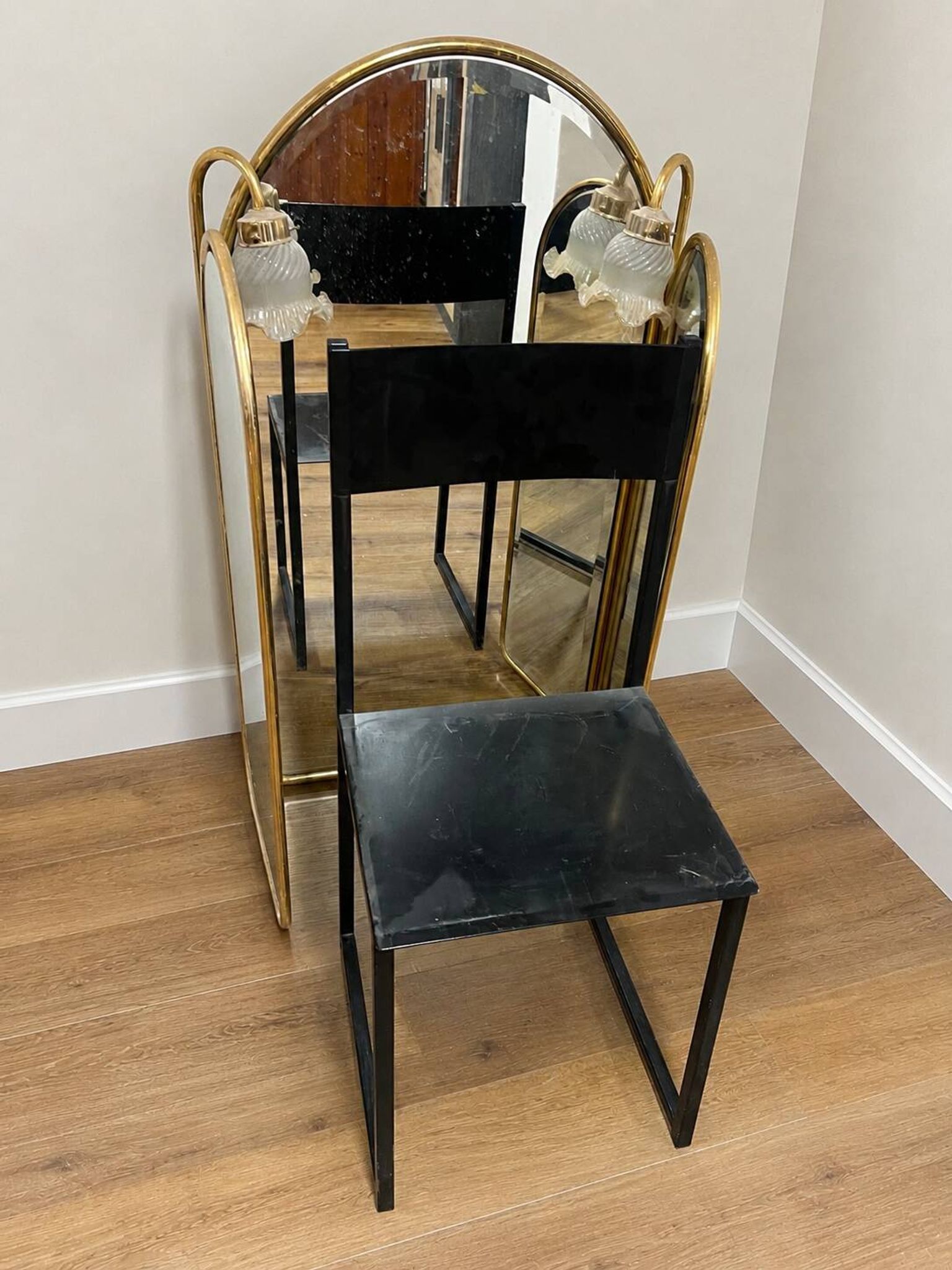 Vintage triptych mirror in brass with wall lights.