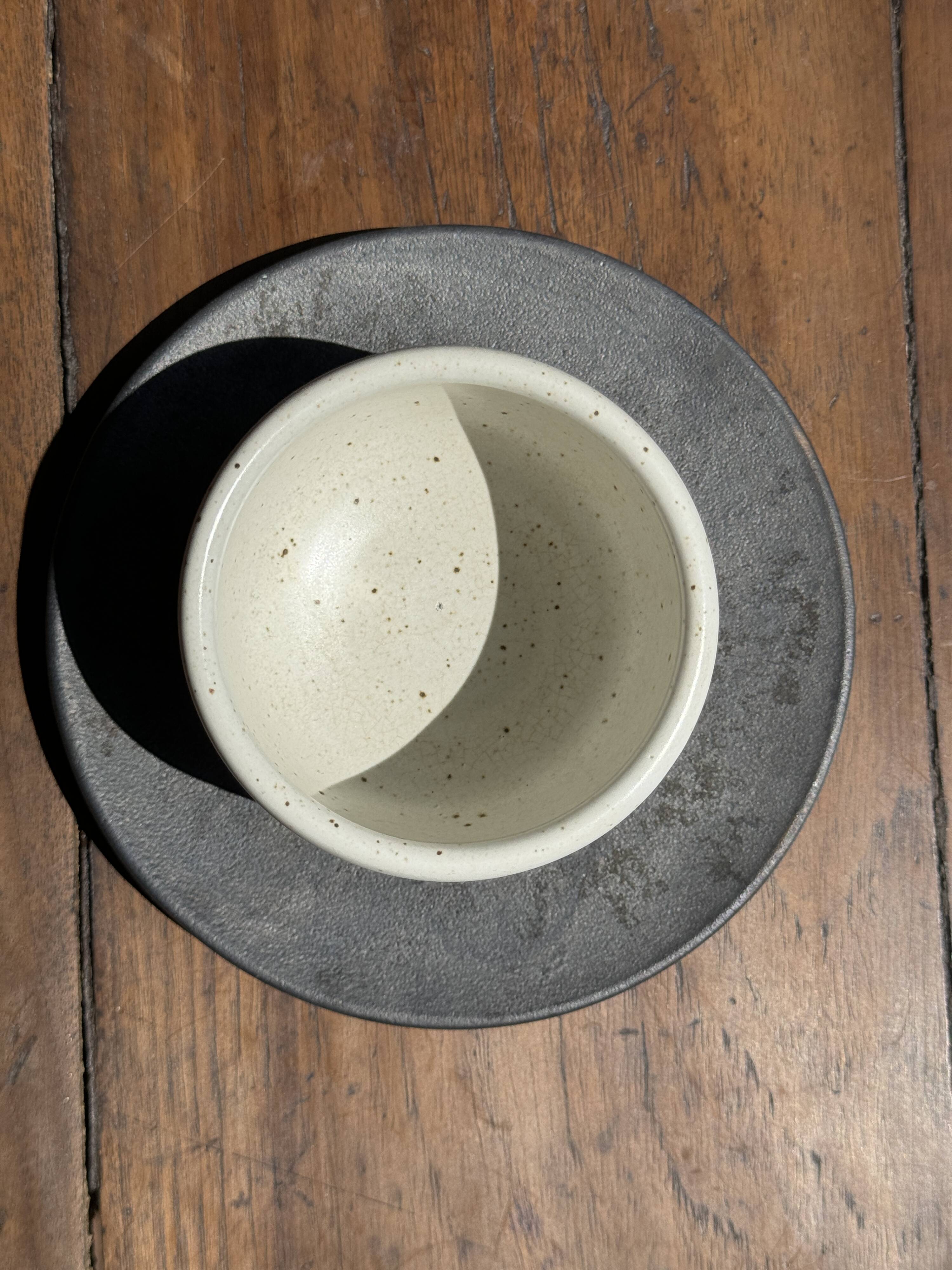 White Indonesian ceramic cup and gray saucer