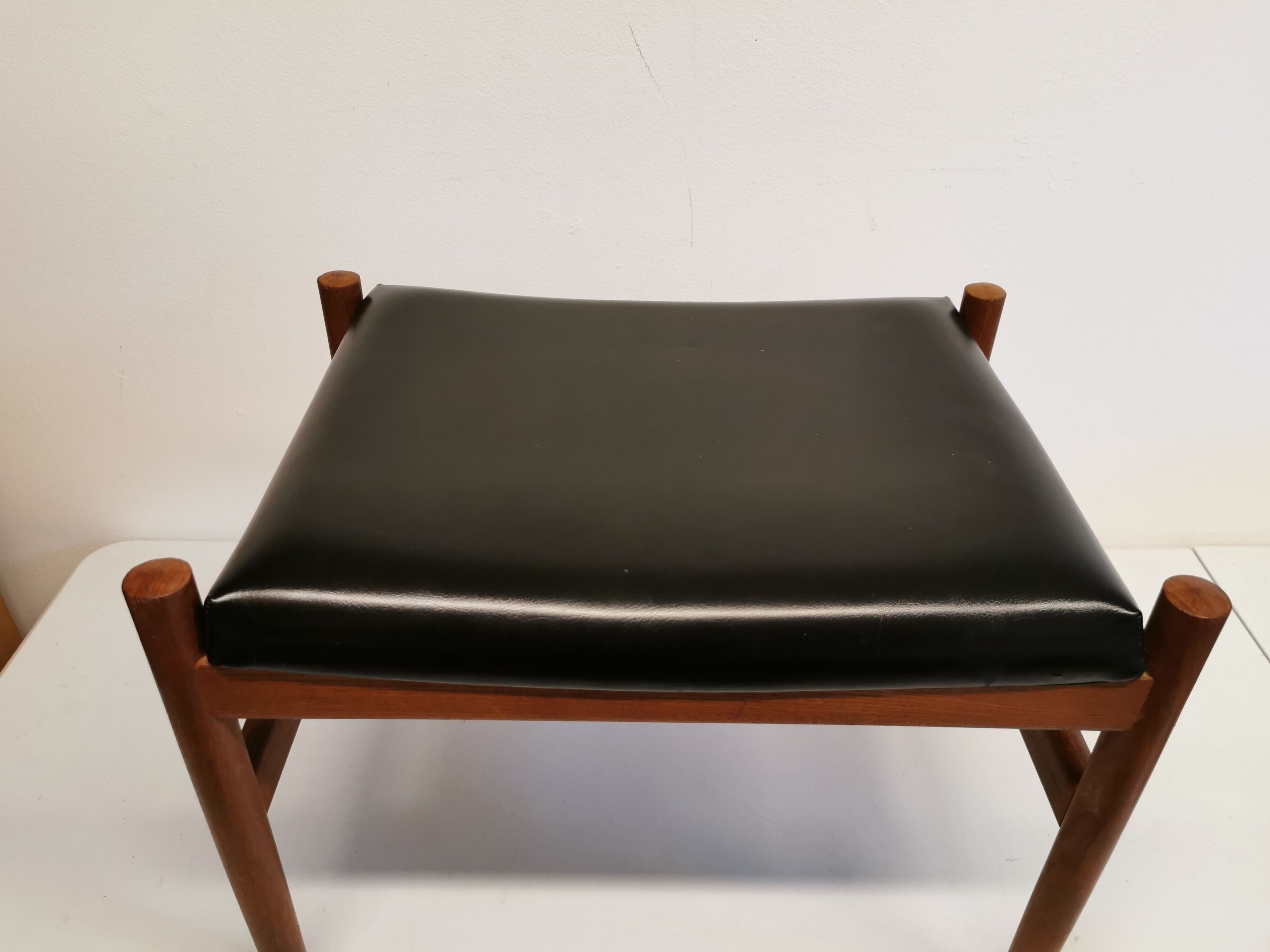 Danish designed footstool, in teak and black skai. Made at Spøttrup furniture factory in the 1960s.