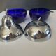 A pair of vintage cobalt glass and silver-plated sugar bowls.