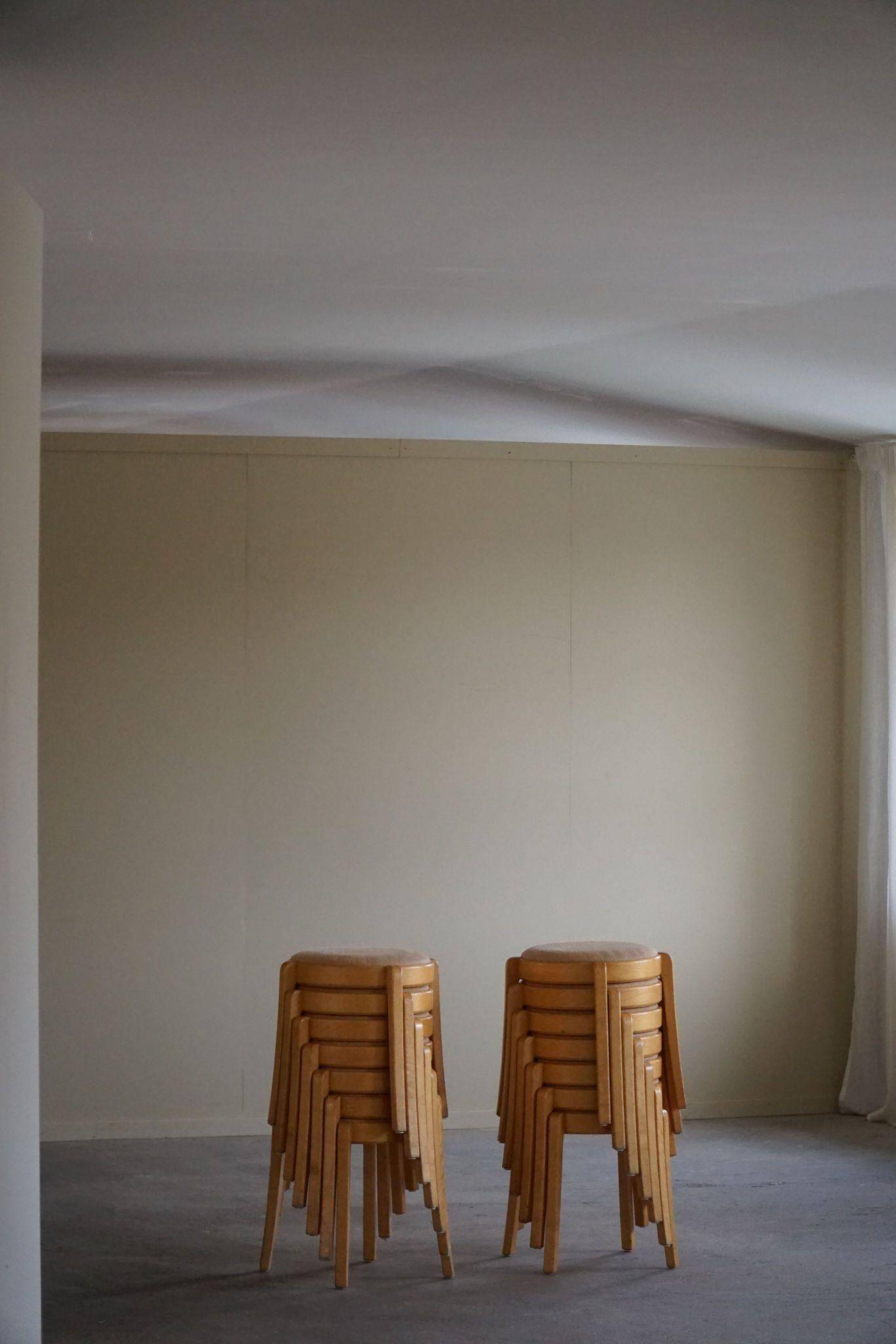 Set of 14 modern Swedish stackable stools in birch and hessian, 1980s.