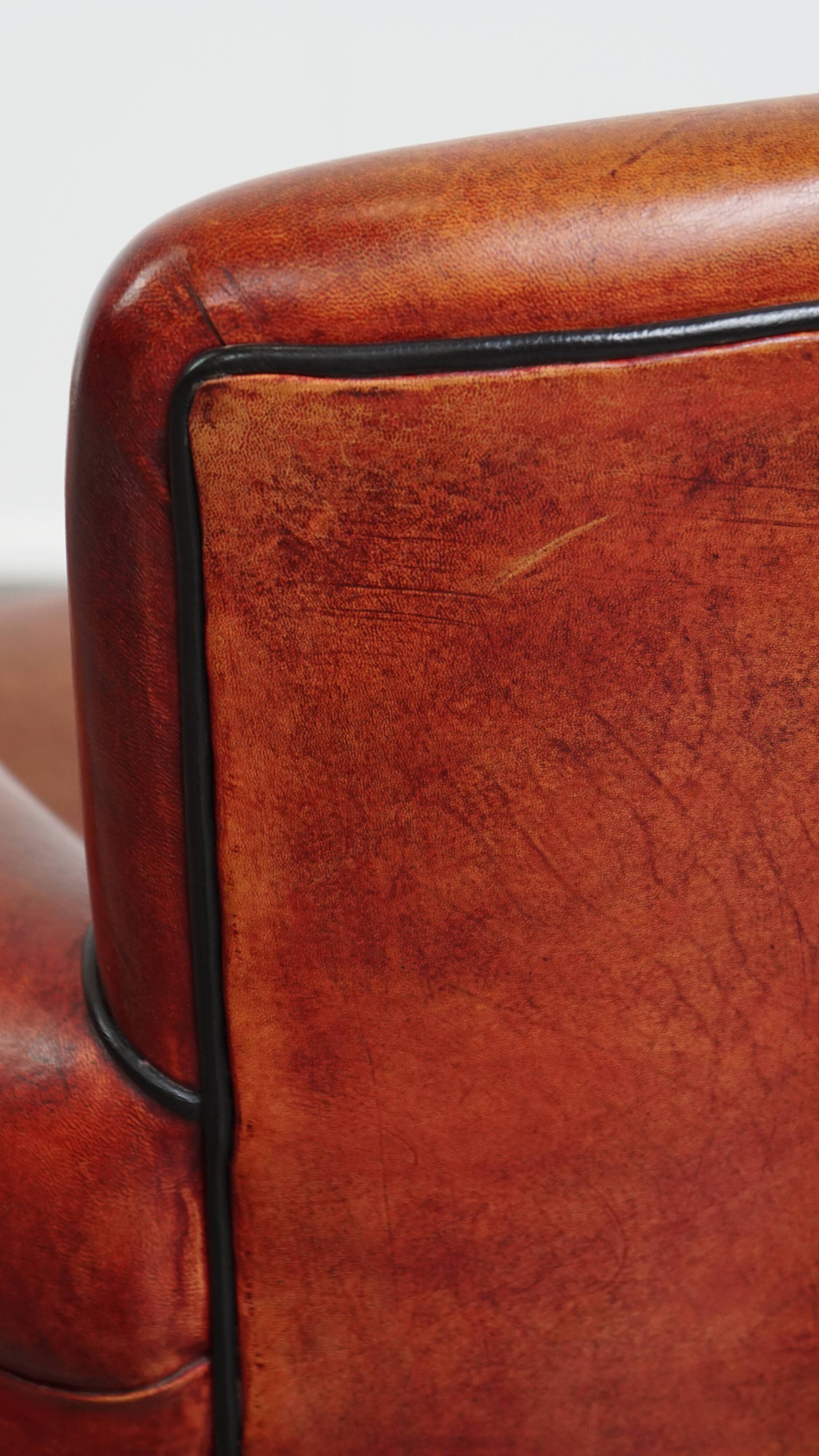 Armchair made of sheepskin leather in a red/brown color