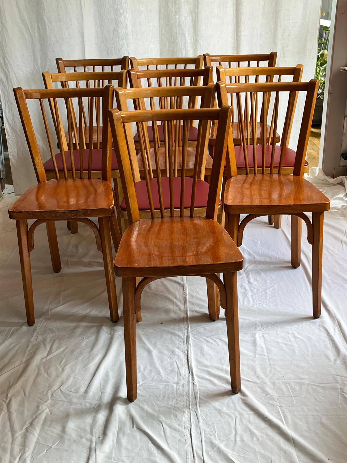 Set of Baumann bistro chairs with a mix of wooden seat and faux leather.