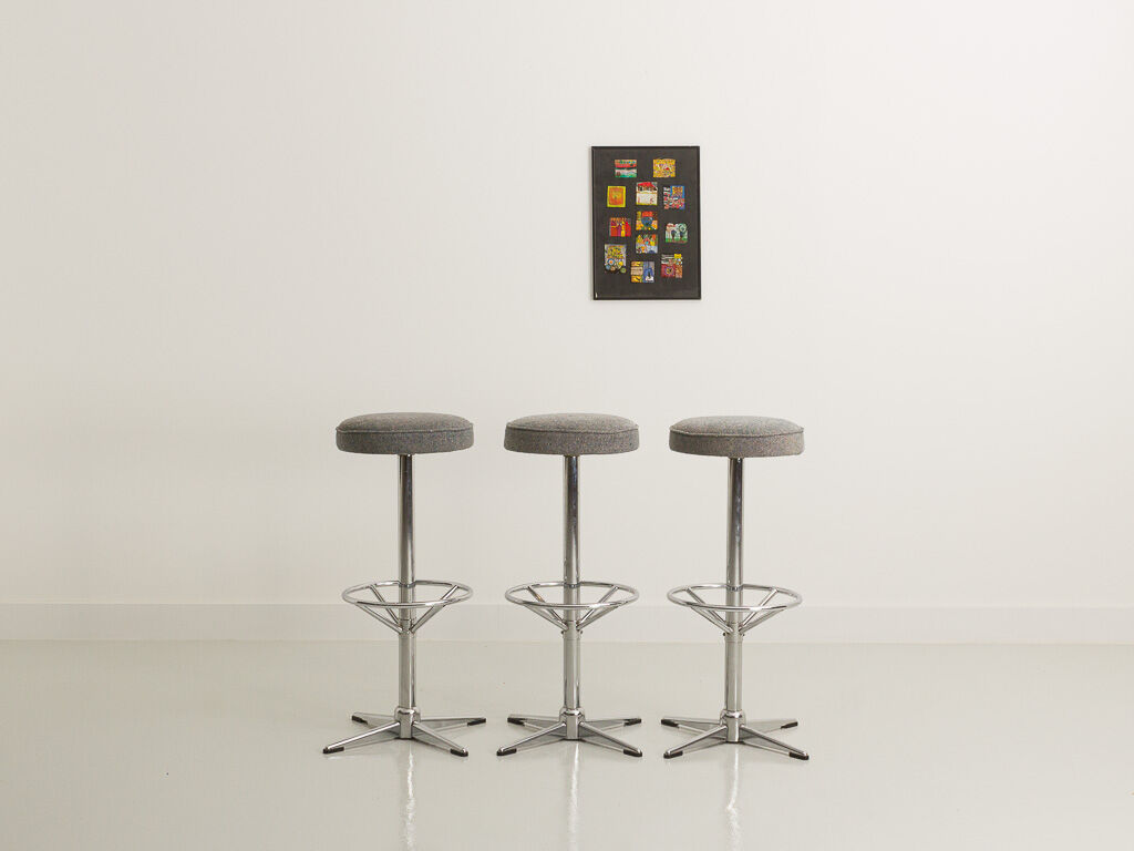 Trio of bar stools with restored seating and chrome-plated steel legs
