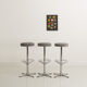 Trio of bar stools with restored seating and chrome-plated steel legs