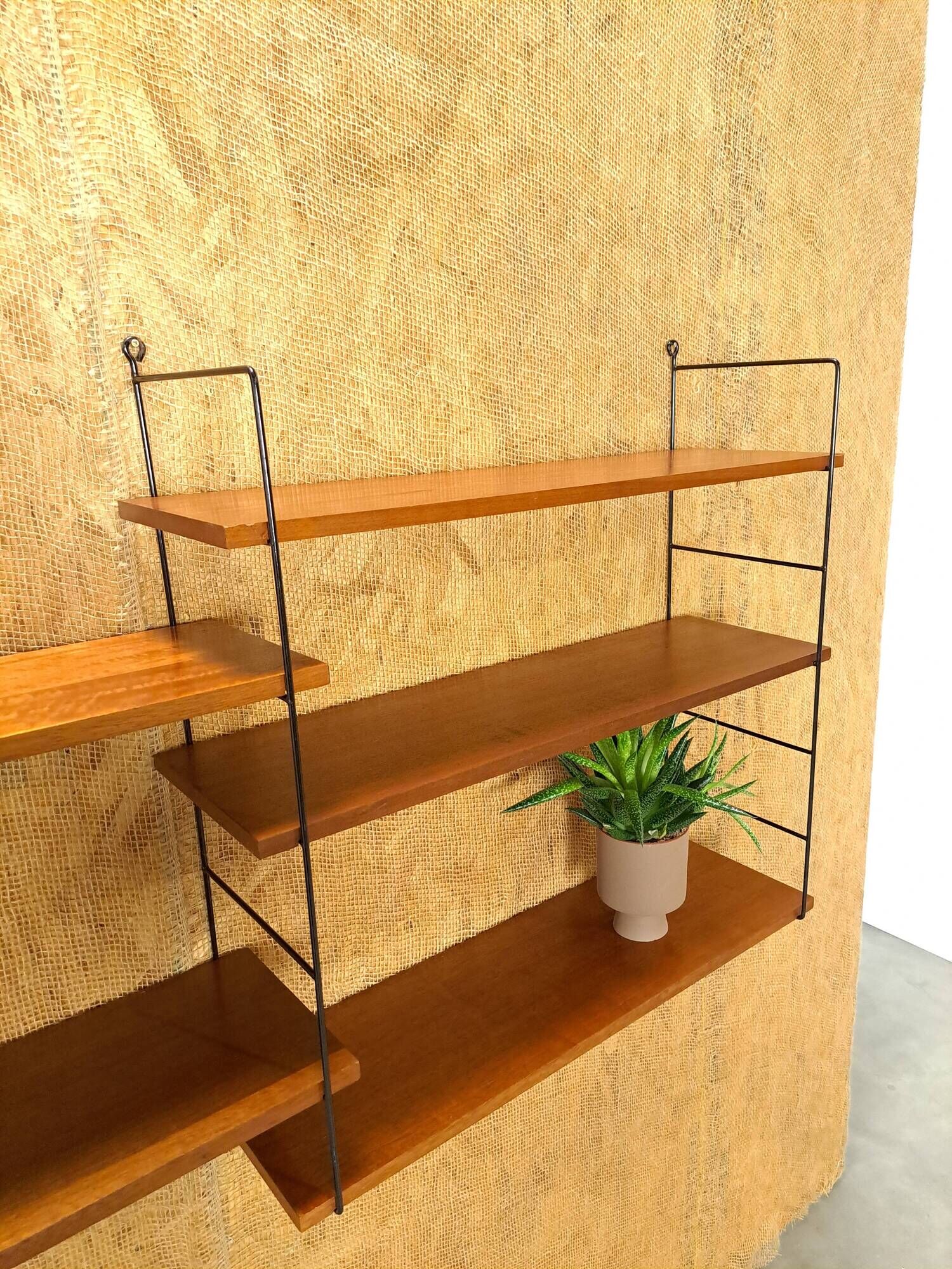 Wall rack with shelves and steel holders, dark wall system