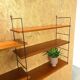 Wall rack with shelves and steel holders, dark wall system