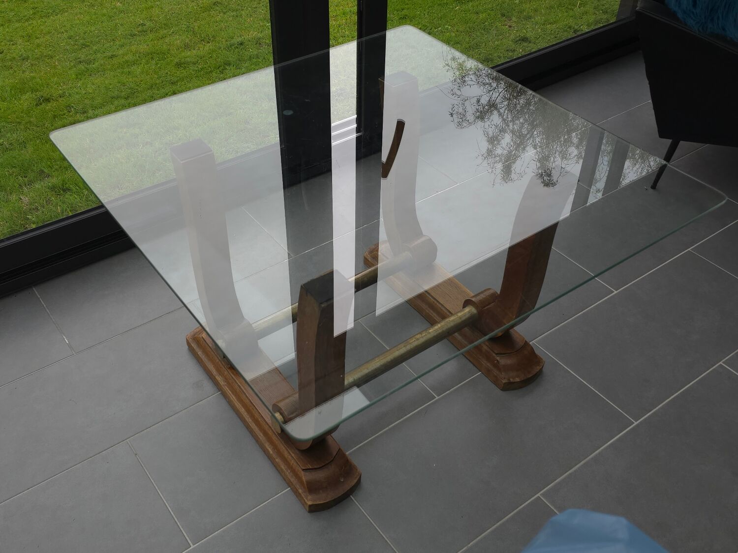 Art Deco coffee table in glass, wood, and brass.