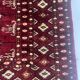 Antique wool rugs with designs on a red background, 20th century.