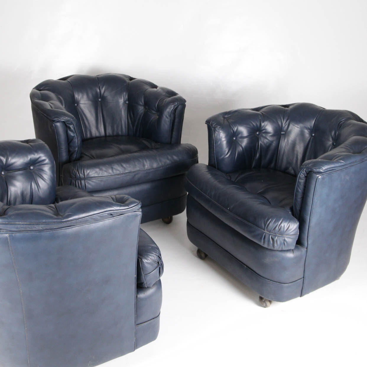 Suite of 3 small armchairs in midnight blue leather with castors