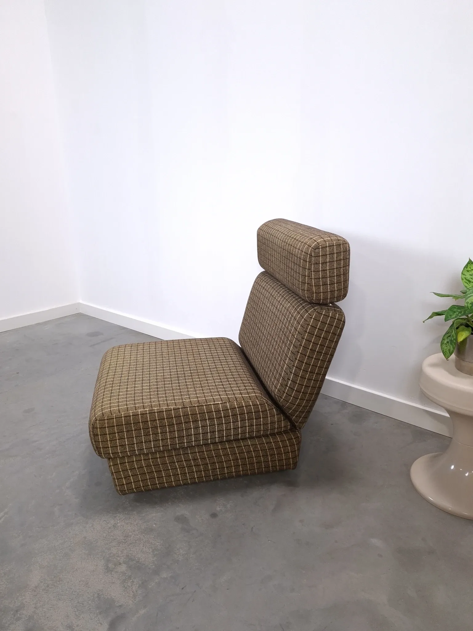 Vintage pull-out sofa bed, brown checked lounge chair with chrome.