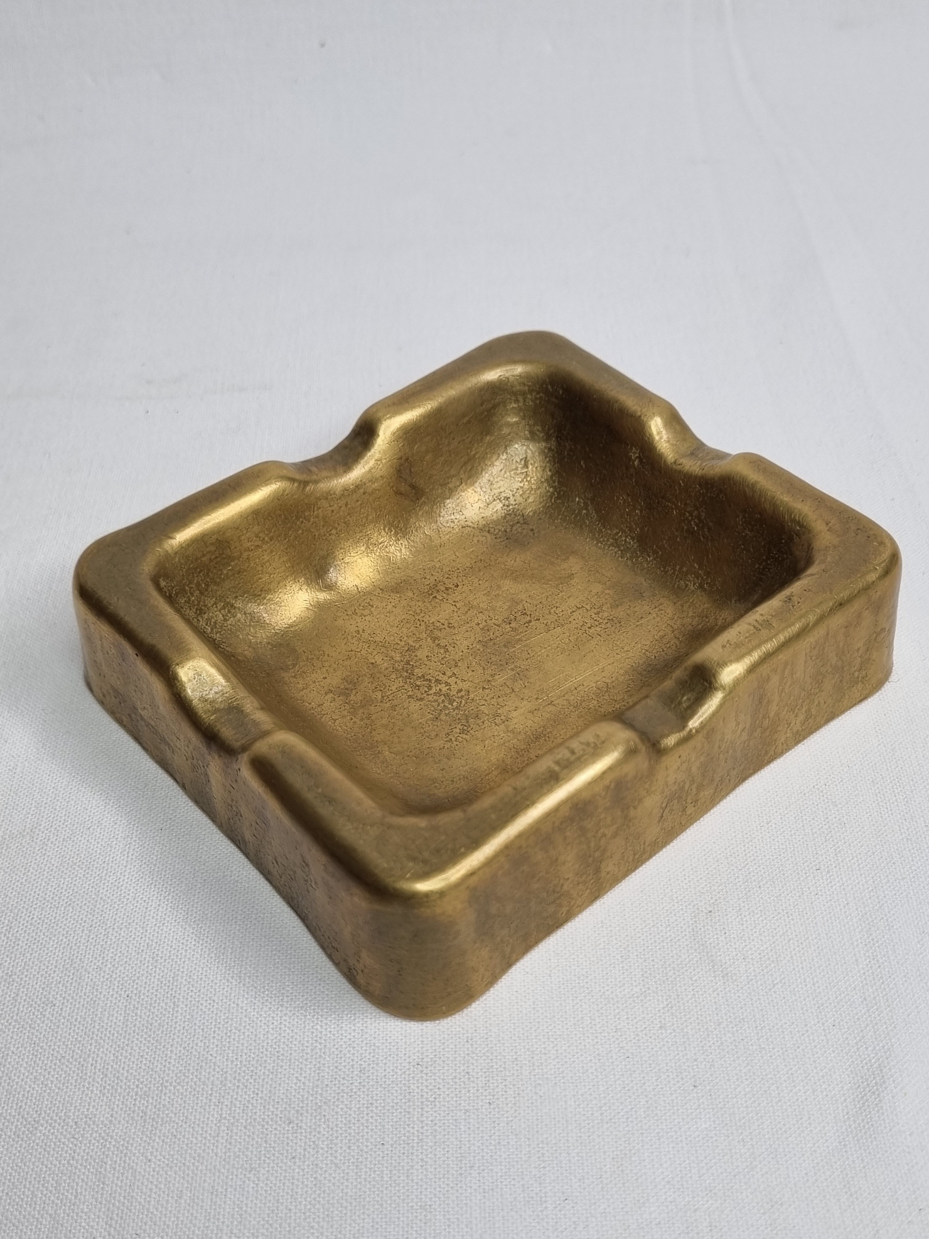 Empty pocket brutalist-inspired ashtray in gilded bronze