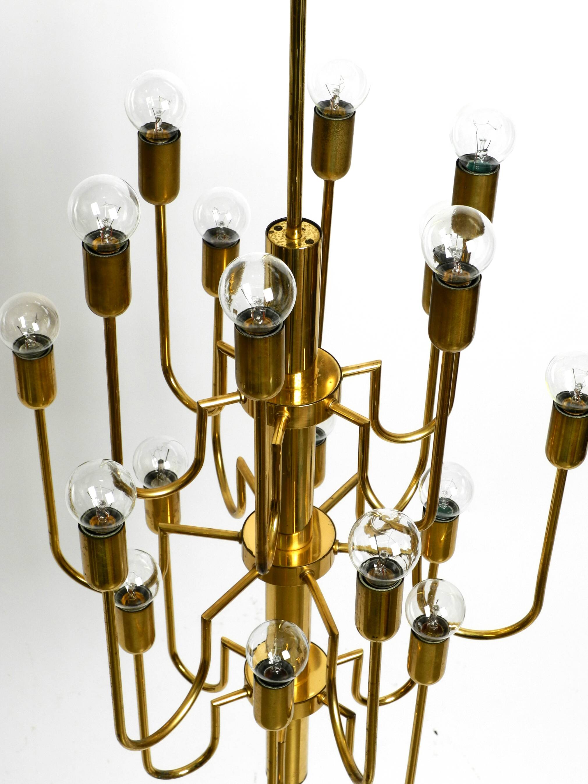 Three staged 18 arm Mid Century brass chandelier with a long brass rod