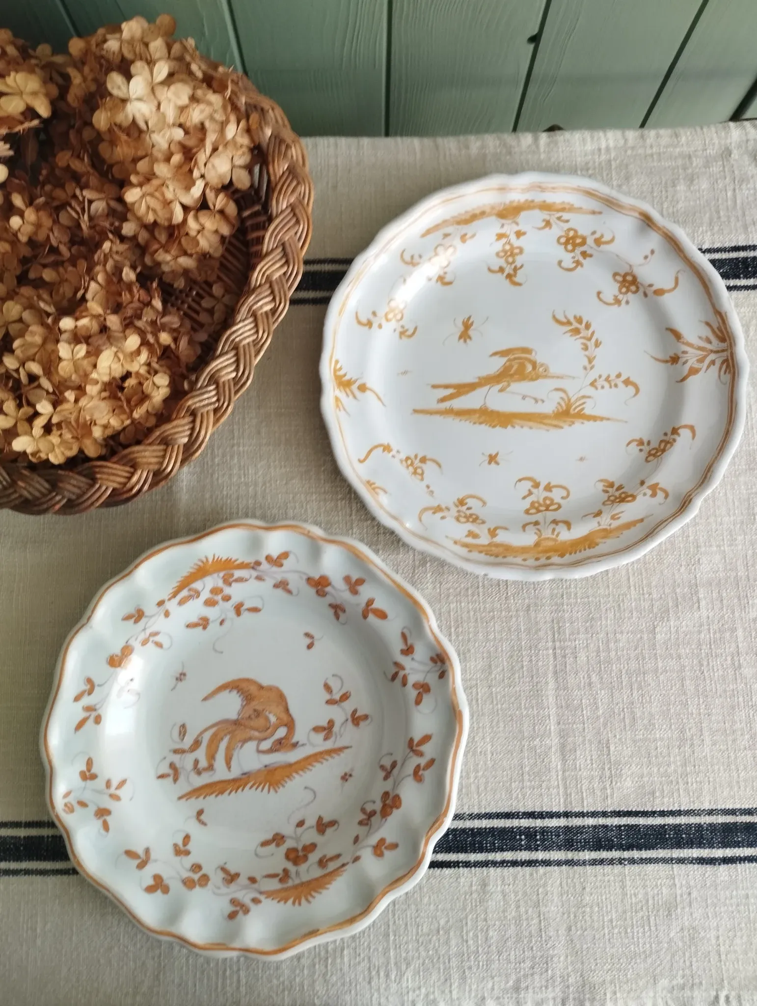 Pair of antique plates with a bird of paradise design in the style of Moustiers.