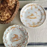 Pair of antique plates with a bird of paradise design in the style of Moustiers.