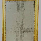Louis XVI mirror in carved and gilded wood with leaf 18th century
