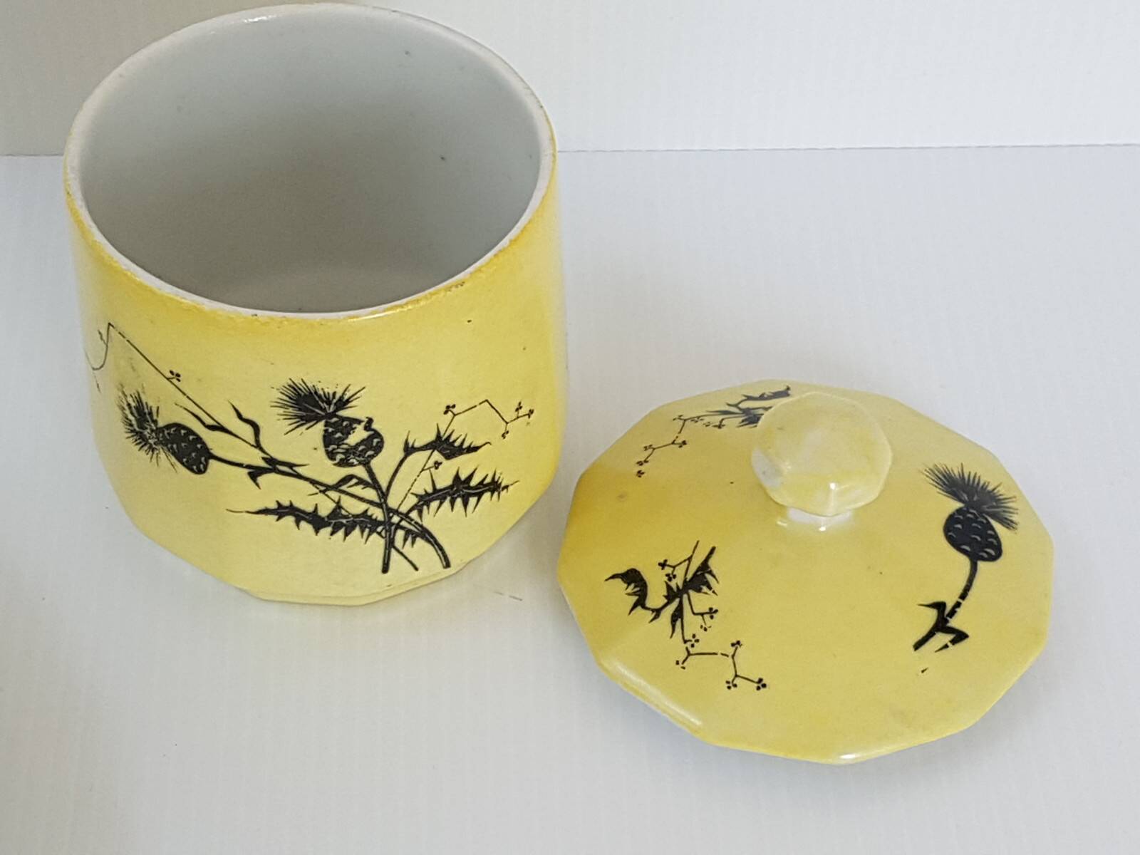 A yellow Art Deco ceramic tobacco service decorated with thistles from the 1920s to 1930s.