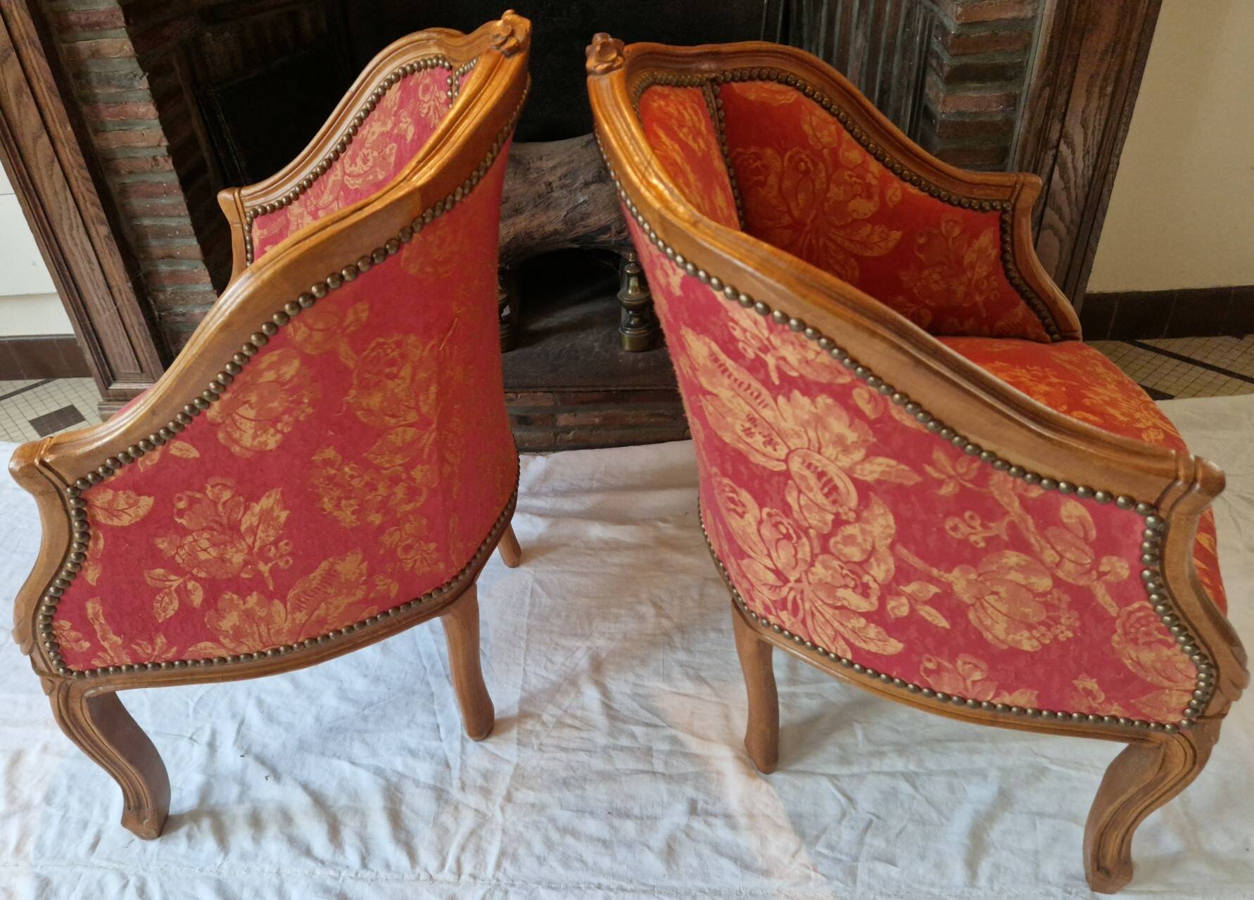 Pair of louis xv cabriolet armchairs with sculpted wood and pink & red floral fabric