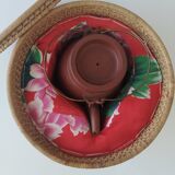 Chinese terracotta teapot with its basket
