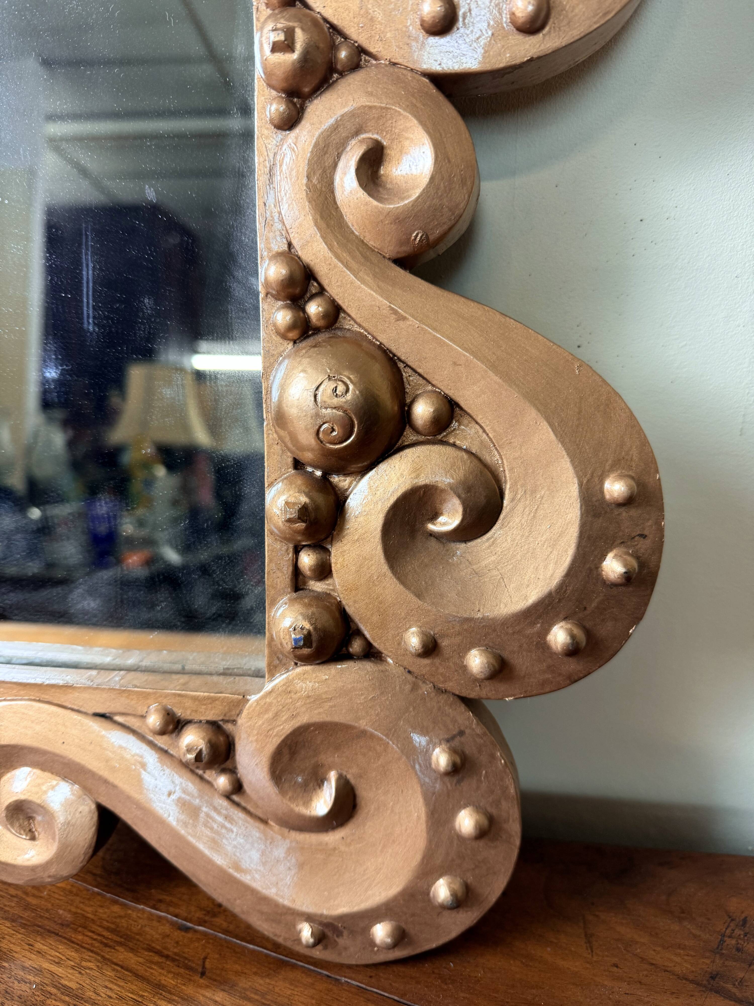 According to the model “the waves” by Jean Boggio: pair of designer gold mirrors circa 1980