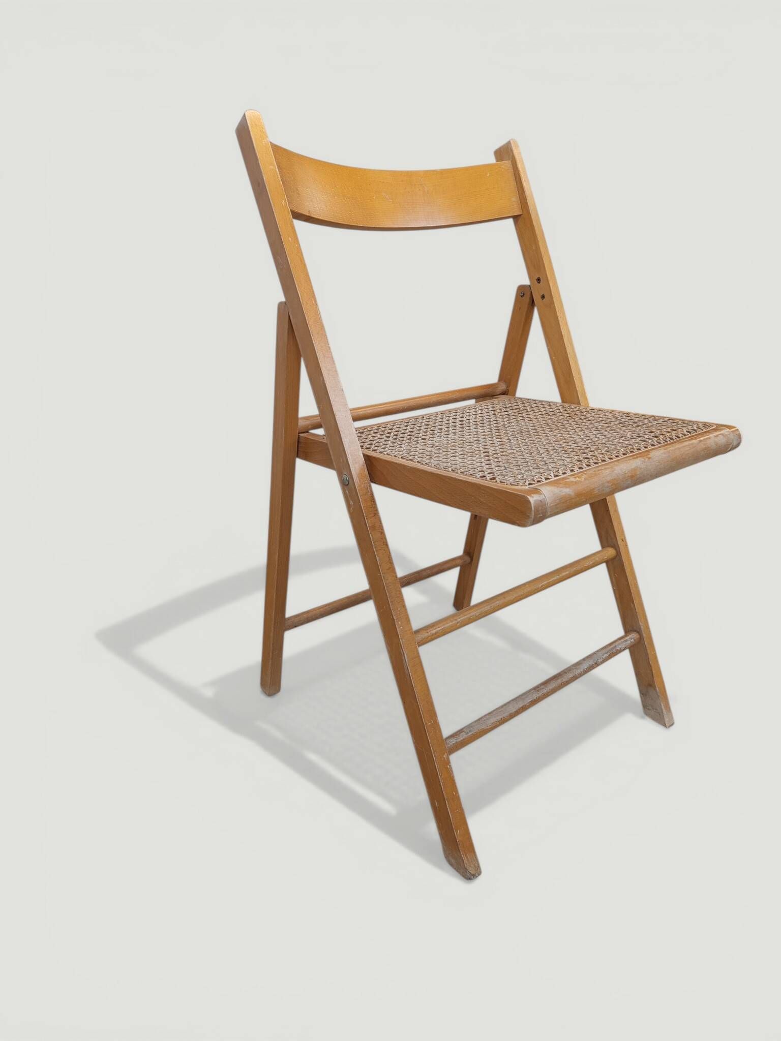 Vintage folding chair with caning.