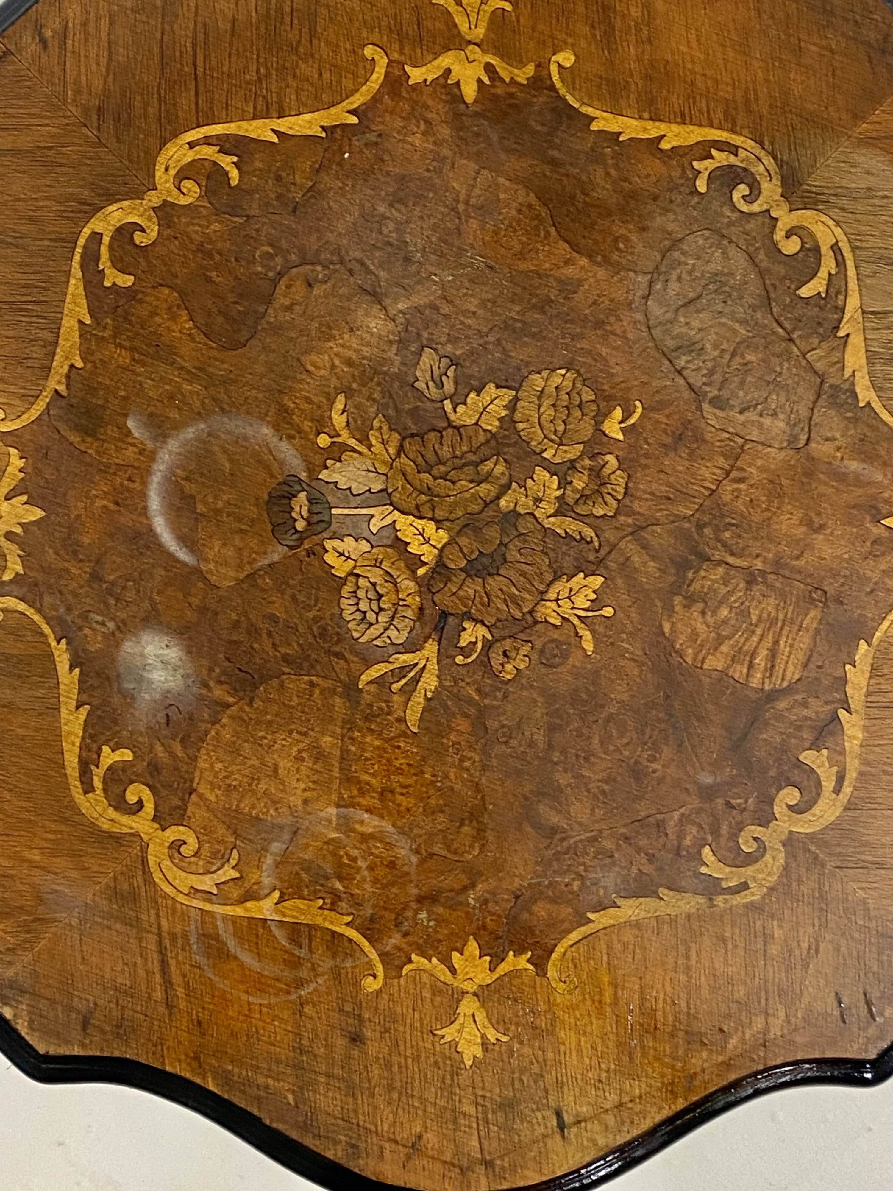 Two-tone black and mahogany pedestal table with mahogany veneer