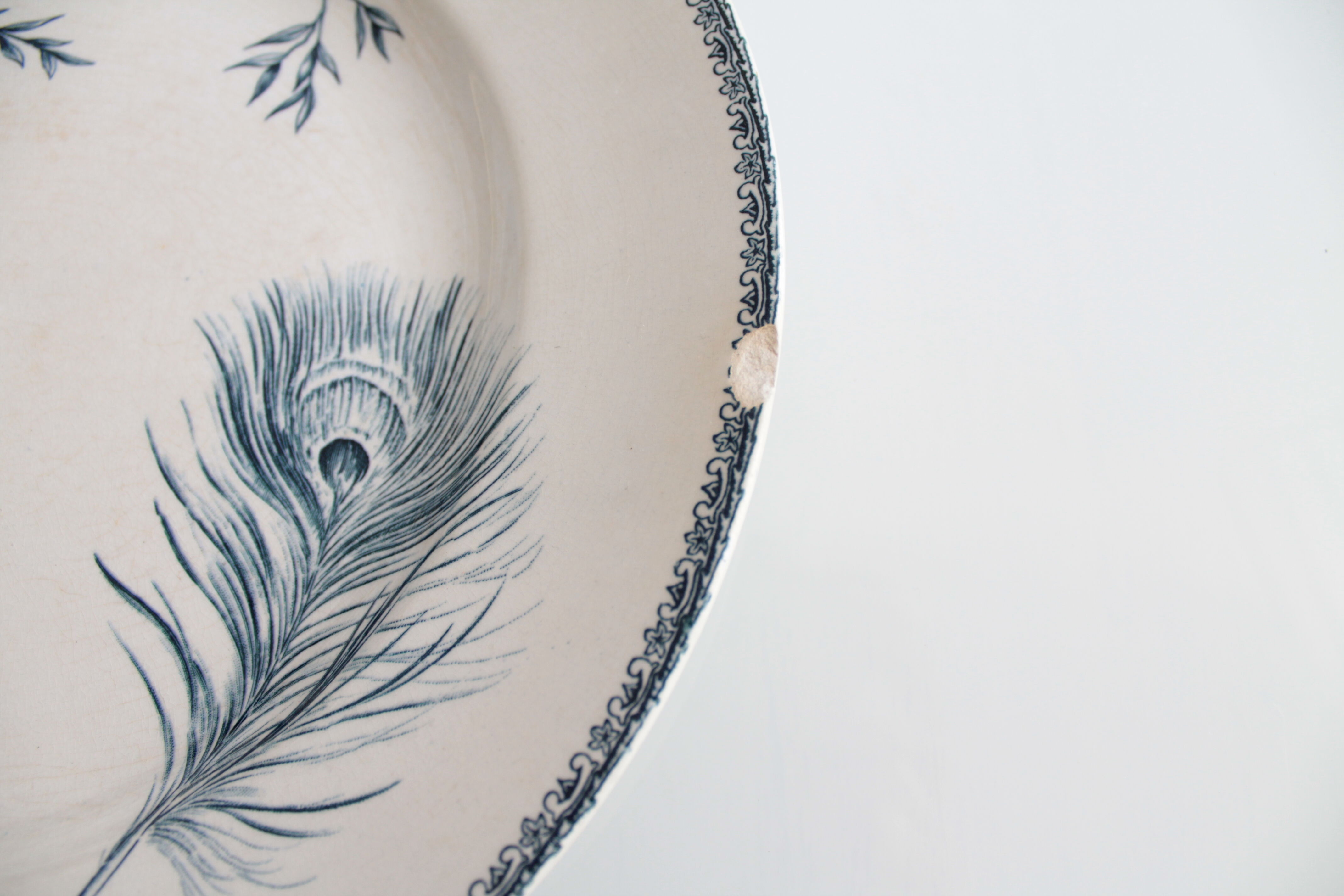 Old dish of opaque porcelain on ground transfer service