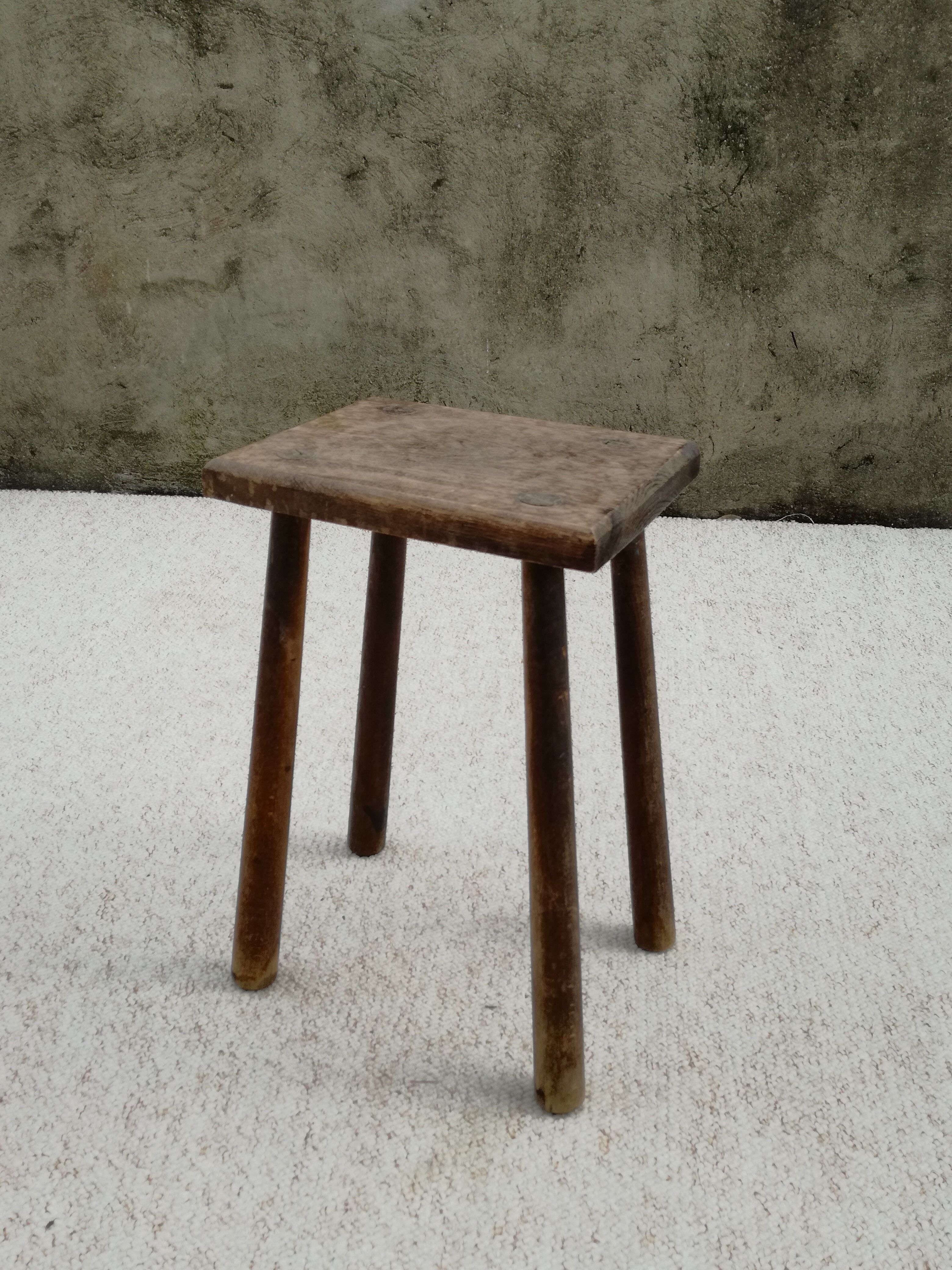 Old wooden stool with log feet