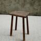 Old wooden stool with log feet