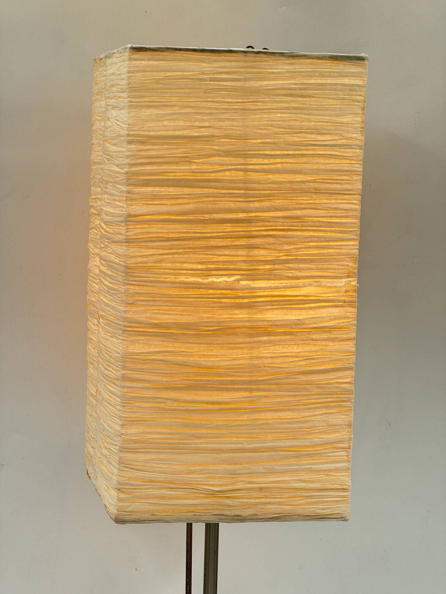 Vintage table lamp made of crumpled rice paper, with a matte metal base.