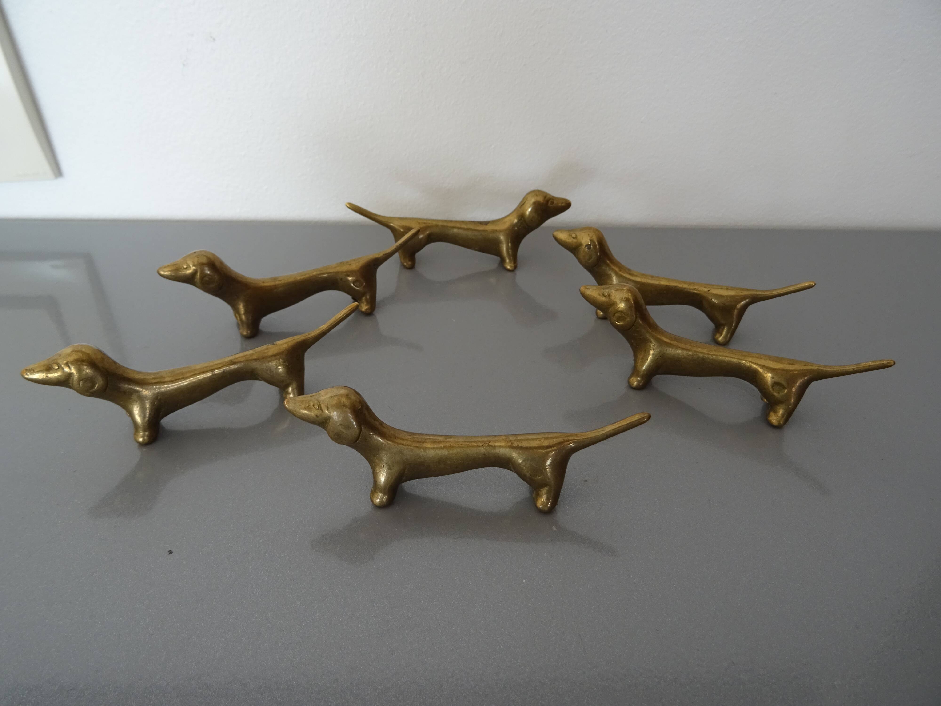 Series of 6 vintage gilded brass dachshund knife holders