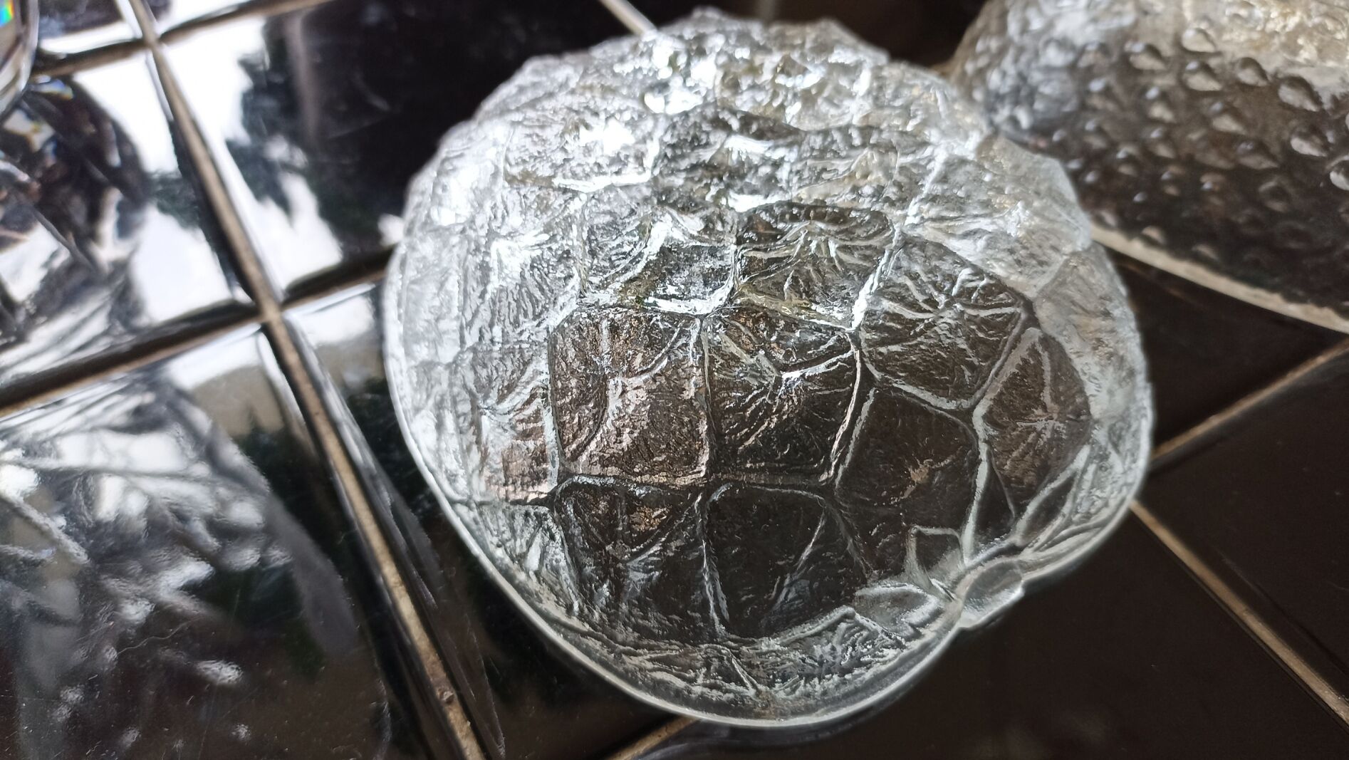 Two molded glass cups in the shape of strawberry and pineapple