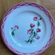 Flat plates Aude Sarreguemines with a rose flower design.